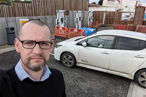 Colin Martin and his EV by a non-functioning charge point